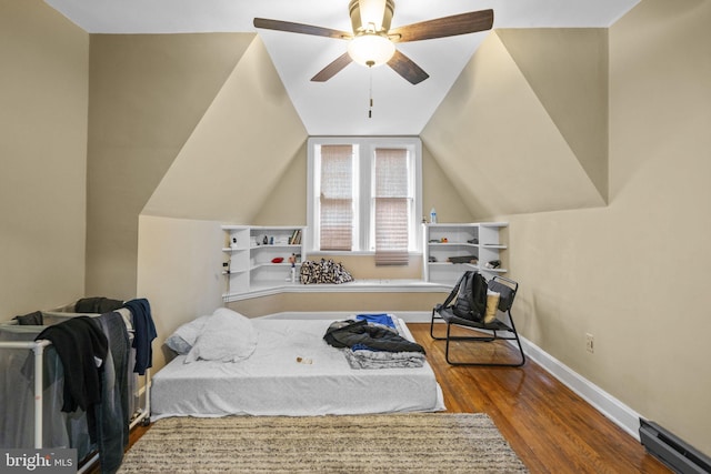 bedroom featuring hardwood / wood-style floors, ceiling fan, and lofted ceiling