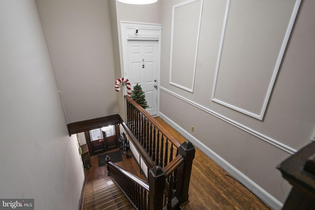 stairway featuring wood-type flooring