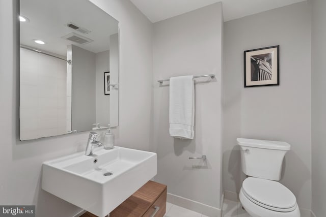 bathroom featuring tile patterned floors, sink, and toilet