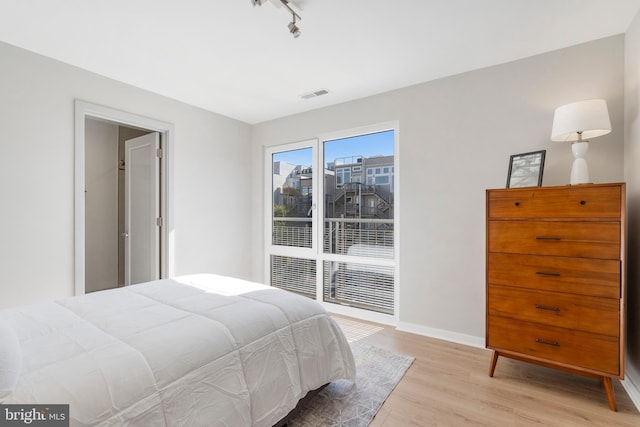 bedroom with light hardwood / wood-style floors