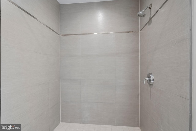 bathroom with a tile shower