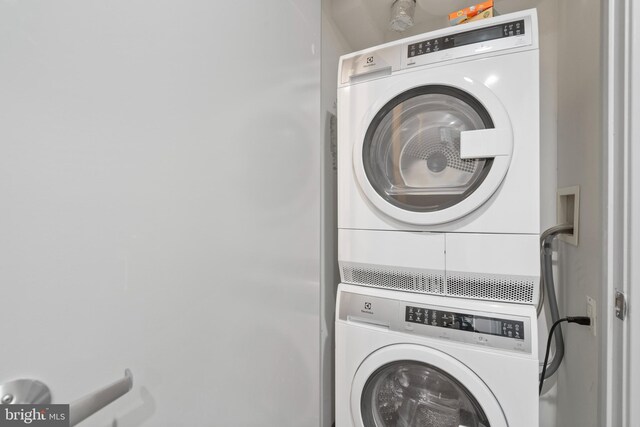 washroom with stacked washer and dryer