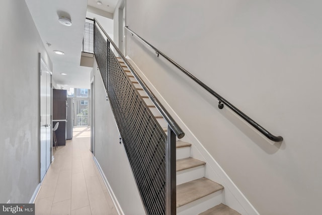 stairway featuring floor to ceiling windows