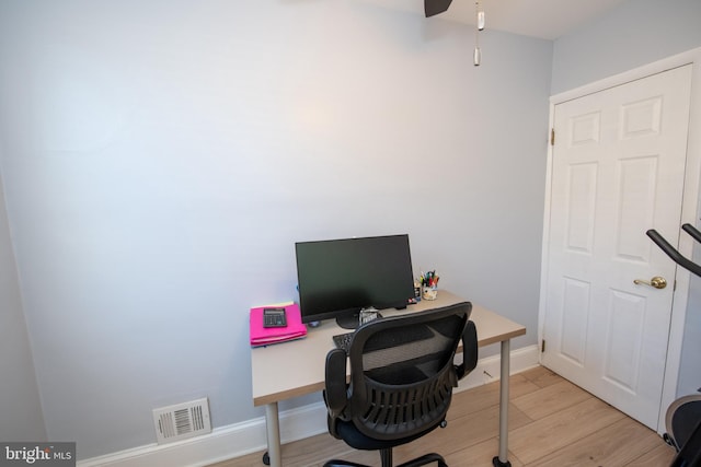 home office with ceiling fan and light hardwood / wood-style floors