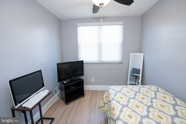 bedroom featuring multiple windows, ceiling fan, and light hardwood / wood-style flooring