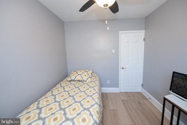 bedroom with ceiling fan and light hardwood / wood-style floors