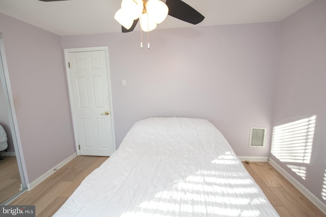 bedroom with ceiling fan and light wood-type flooring