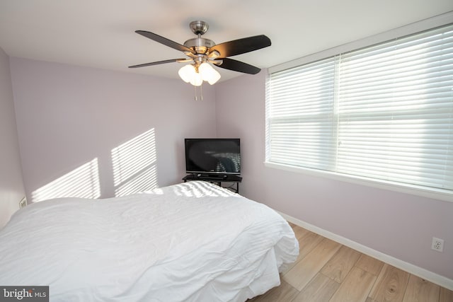 bedroom with light hardwood / wood-style floors and ceiling fan