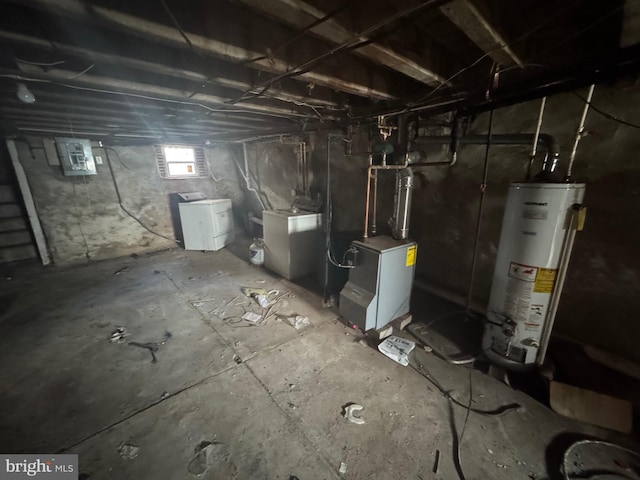 basement featuring washer / clothes dryer, electric panel, and gas water heater