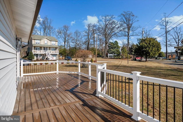 wooden deck featuring a yard