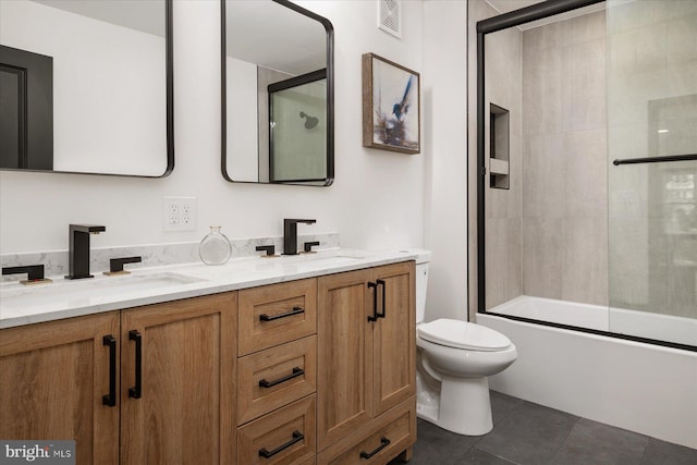 full bathroom with enclosed tub / shower combo, tile patterned floors, toilet, and vanity