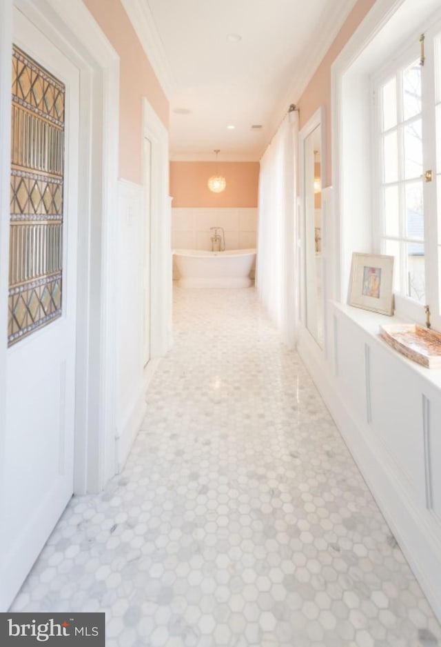 hall featuring crown molding and tile patterned flooring