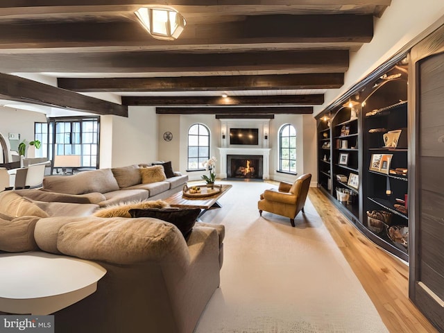 living room with beamed ceiling and wood-type flooring