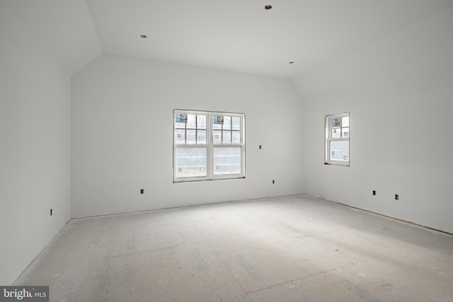 unfurnished room featuring lofted ceiling