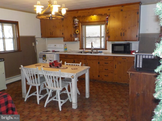 kitchen featuring a kitchen breakfast bar, white range with electric stovetop, sink, an inviting chandelier, and hanging light fixtures