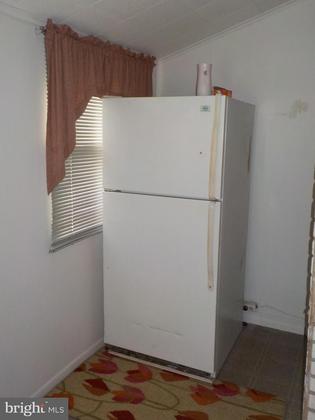 kitchen featuring white fridge and crown molding