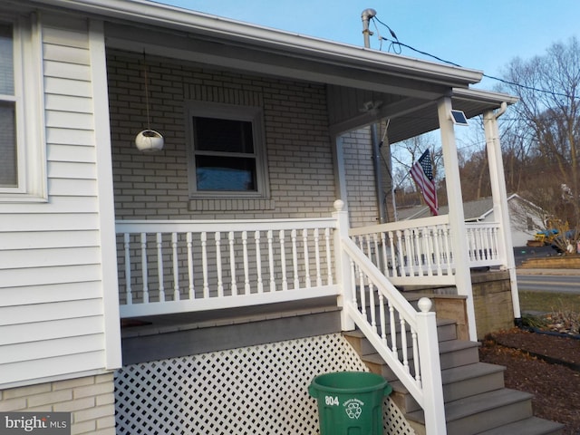 view of exterior entry with covered porch