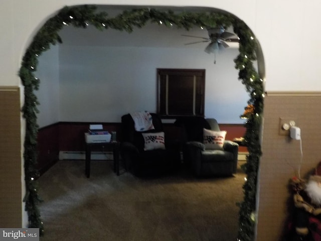 sitting room featuring carpet and a baseboard heating unit