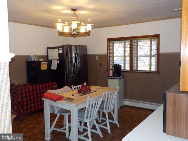 dining space with a chandelier, a baseboard radiator, and ornamental molding