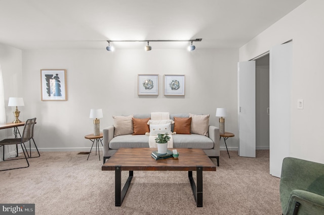 living room featuring rail lighting and light colored carpet