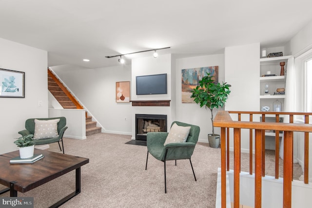 living room featuring light carpet and track lighting