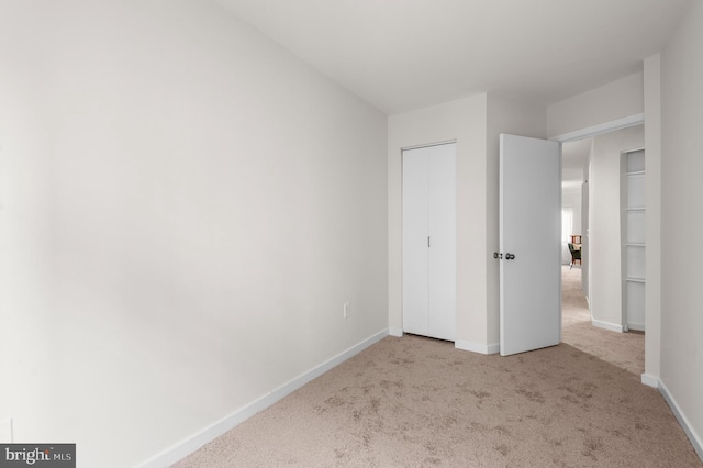 unfurnished bedroom with light carpet