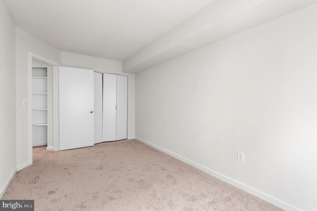 unfurnished bedroom featuring light carpet