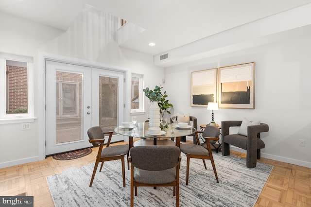 dining room with french doors and light parquet floors