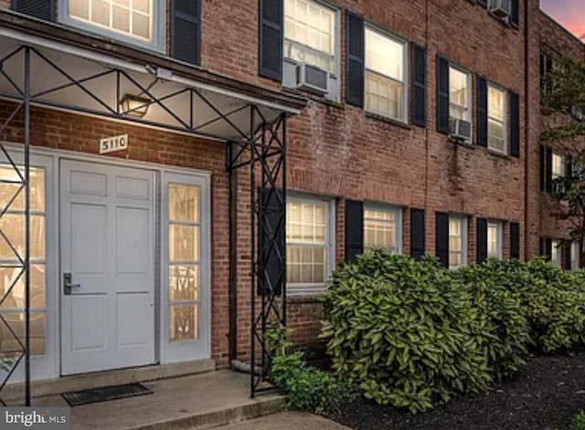 view of exterior entry at dusk