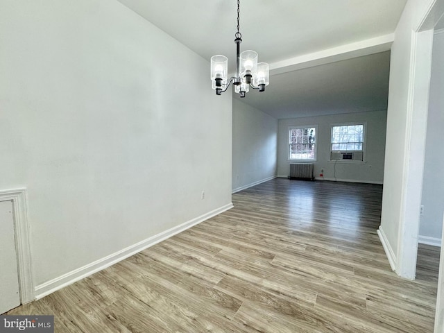 unfurnished dining area with radiator heating unit, light hardwood / wood-style floors, cooling unit, and a notable chandelier