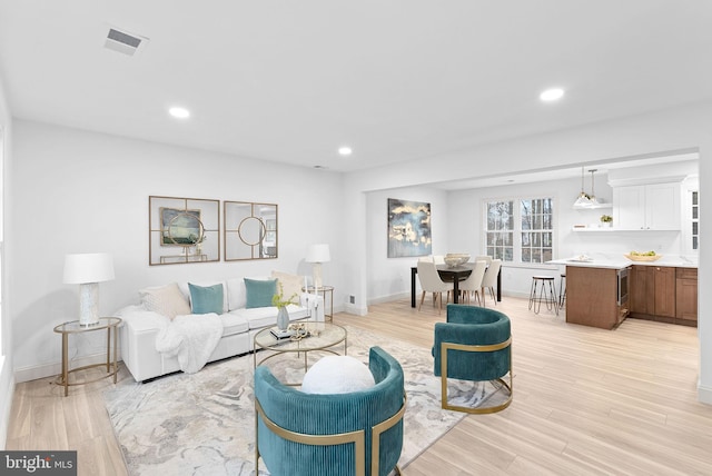 living room with light hardwood / wood-style flooring