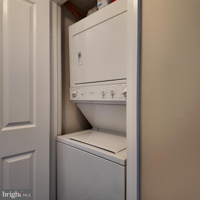 laundry area with stacked washer and dryer