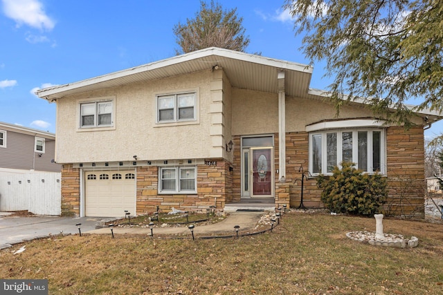 view of front of home featuring a garage and a front lawn