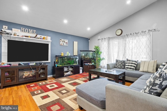 living room with lofted ceiling and hardwood / wood-style flooring