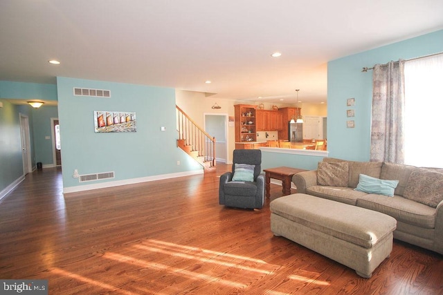 living room with dark hardwood / wood-style flooring