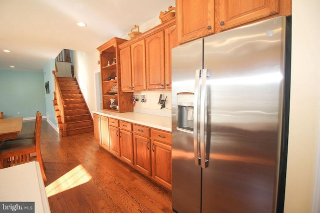 kitchen featuring stainless steel fridge and dark wood-type flooring