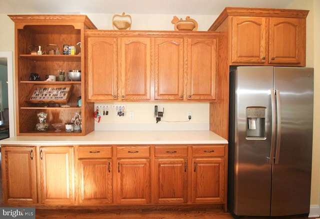 kitchen featuring stainless steel refrigerator with ice dispenser