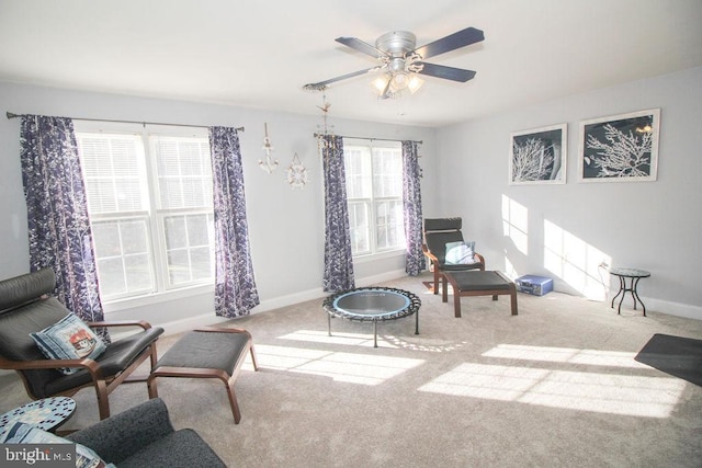 living area with ceiling fan and light colored carpet