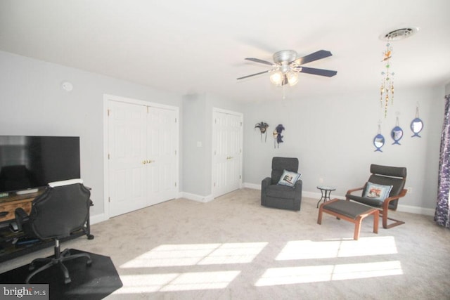 carpeted office with ceiling fan