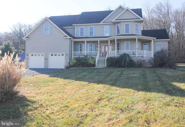 view of front of home with covered porch, a garage, and a front yard