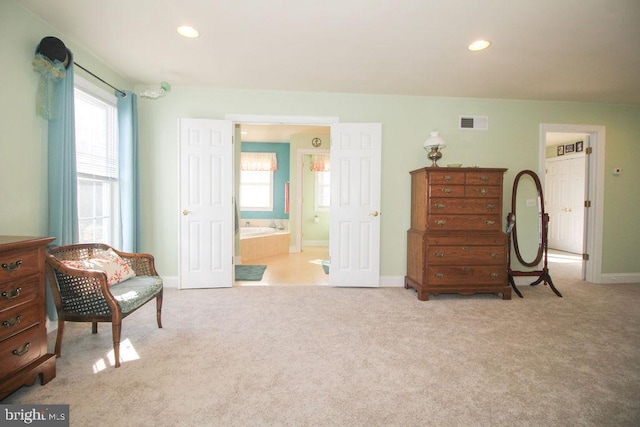 living area featuring light carpet