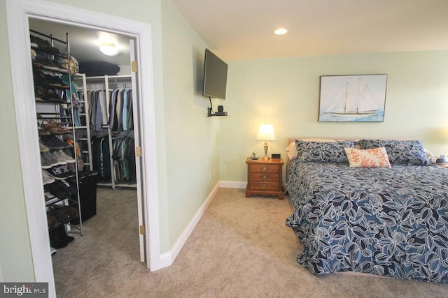 bedroom featuring carpet flooring, a spacious closet, and a closet