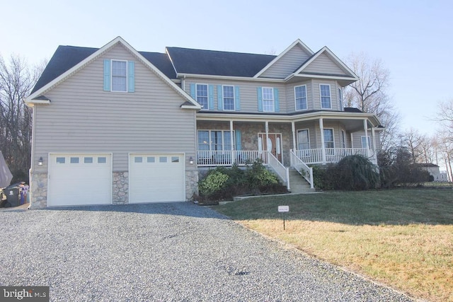 view of front of house featuring a front yard, a porch, and a garage