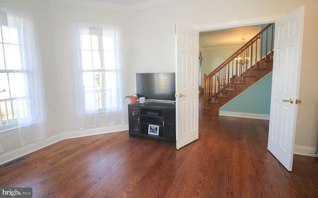 living room with dark hardwood / wood-style floors and ornamental molding