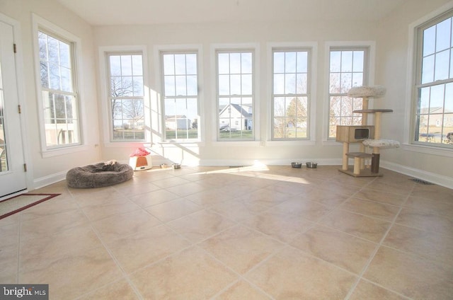 unfurnished sunroom featuring a healthy amount of sunlight