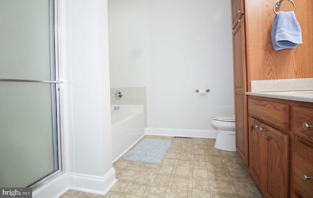 bathroom featuring a bathtub, vanity, and toilet