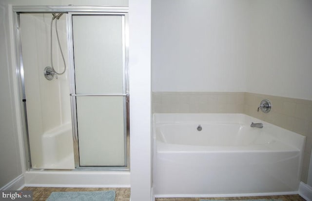 bathroom with separate shower and tub