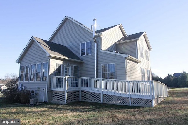 back of property featuring a wooden deck, a yard, and cooling unit