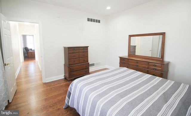 bedroom with hardwood / wood-style floors