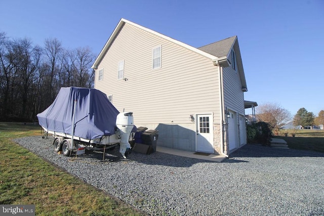 rear view of property with a garage